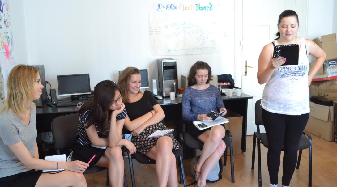 Teenage volunteers work as a group to find the best stories for the magazine Journalism volunteers discuss their story ideas as part of their Journalism Project for teenagers